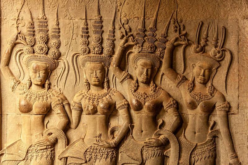 Detailed bas-reliefs at Angkor Wat depicting Hindu and Buddhist scenes