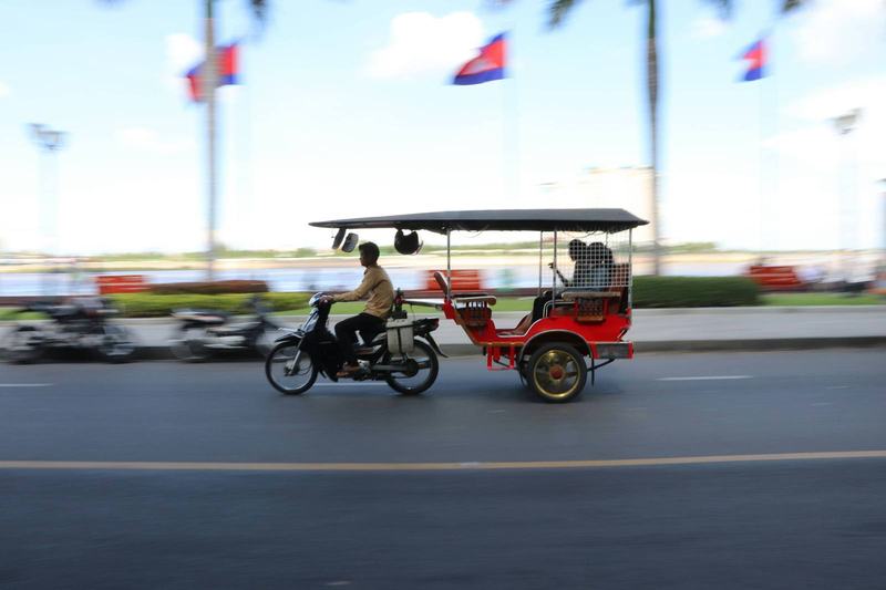 Tuk-tuks, bicycles, and cars at Angkor Wat, Cambodia
