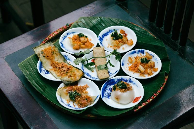 Vietnamese bánh bèo and steamed rice cakes served on small plates with shrimp topping