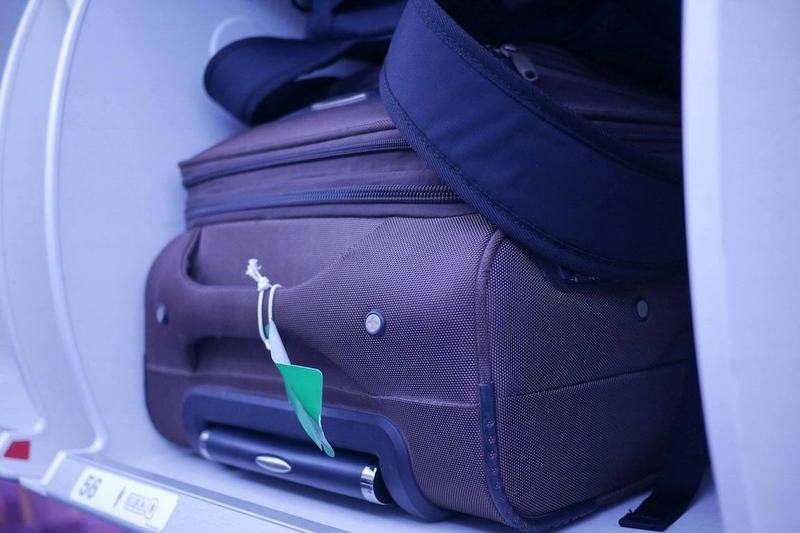 Carry-on baggage stored in an aircraft overhead bin on a regional flight