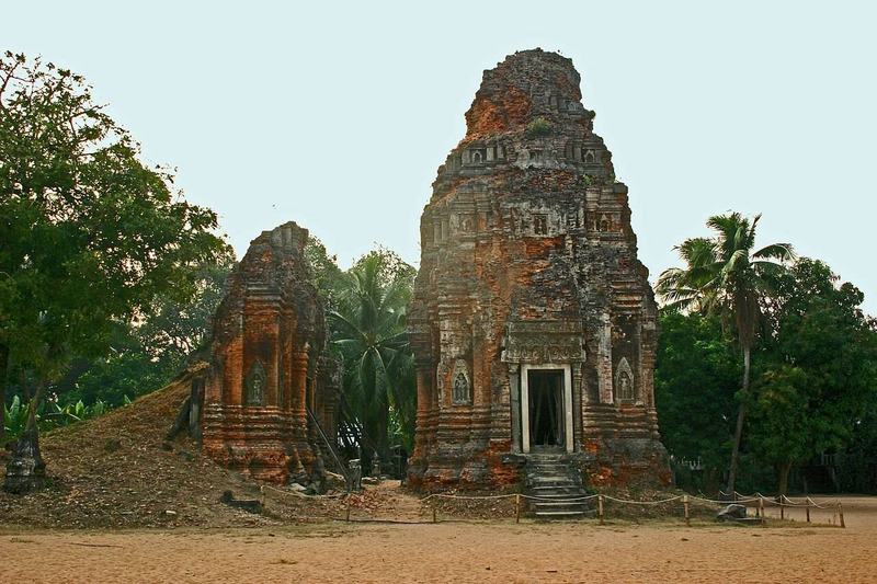 Four brick towers of Lolei temple surrounded by fields where the baray once was