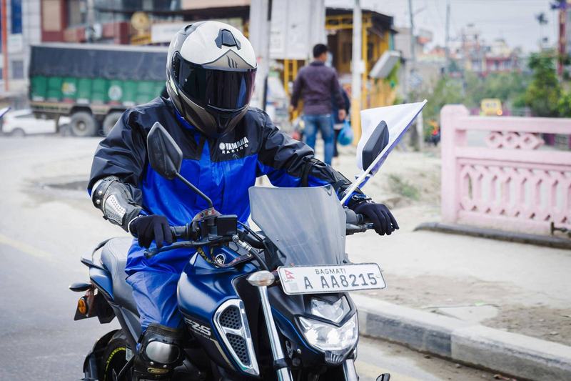 Motorbike rider wearing a helmet in Southeast Asian traffic