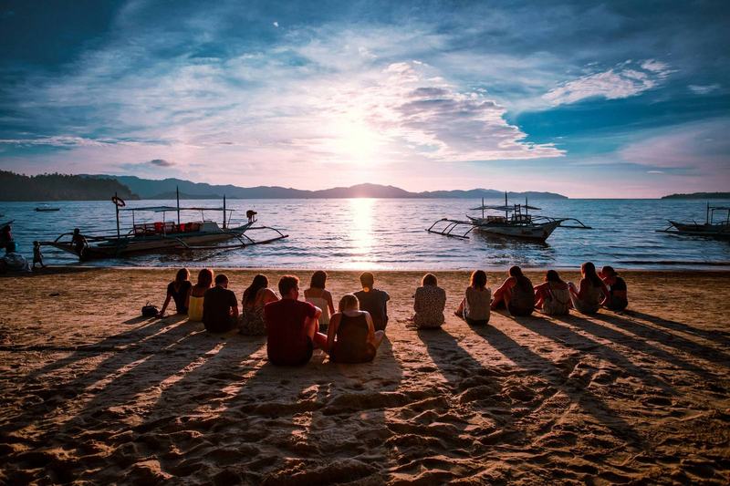 Relaxed traveler watching sunset in Southeast Asia after a safe journey