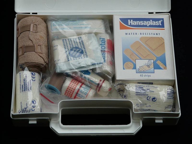 Basic travel medical kit with pills, repellent, and first aid items